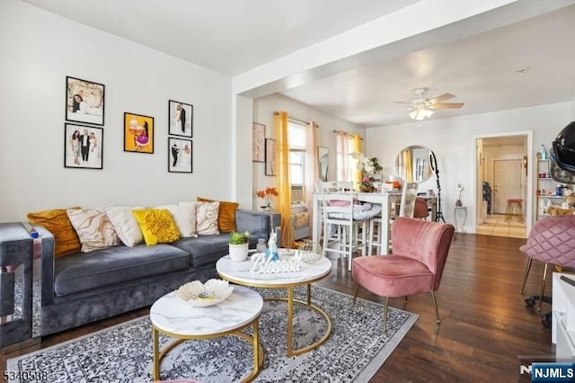 living room featuring a ceiling fan and wood finished floors