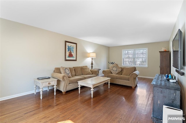 living room with dark wood-type flooring and baseboards