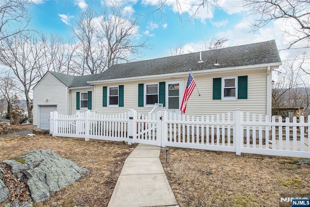 ranch-style home featuring a garage, a shingled roof, and a fenced front yard