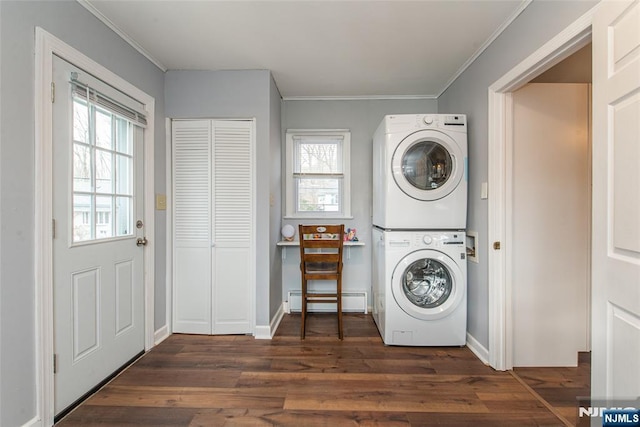 laundry room featuring a baseboard heating unit, laundry area, wood finished floors, stacked washer / drying machine, and crown molding