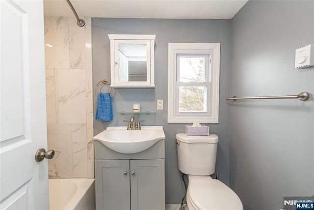 bathroom with toilet, tub / shower combination, and vanity