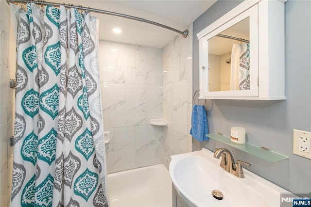 full bathroom featuring shower / bathtub combination with curtain and a sink