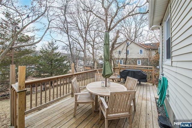 wooden deck featuring outdoor dining area