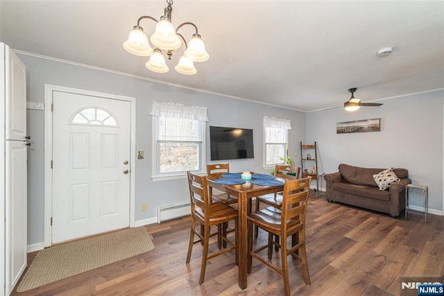 dining area with crown molding, baseboard heating, and wood finished floors