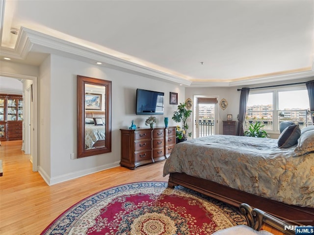 bedroom with light wood-style flooring, baseboards, access to exterior, ornamental molding, and a tray ceiling