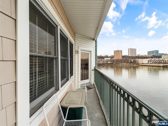 balcony with a water view and a city view