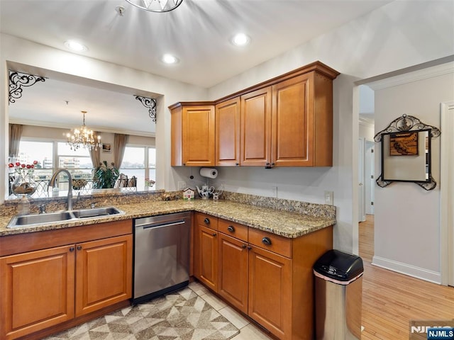 kitchen featuring brown cabinets, light stone countertops, crown molding, stainless steel dishwasher, and a sink