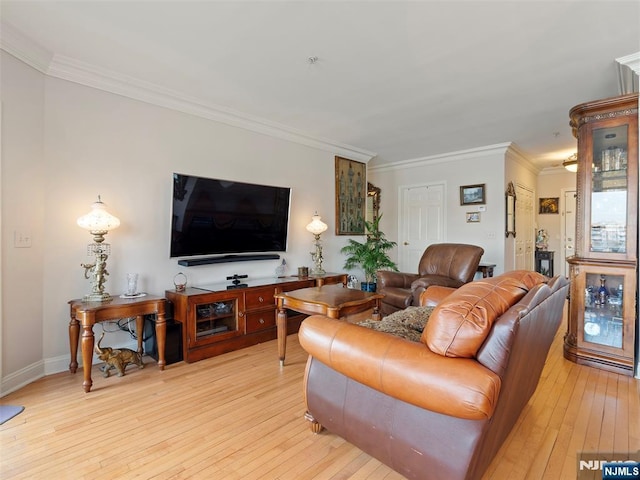 living area with ornamental molding and light wood-type flooring