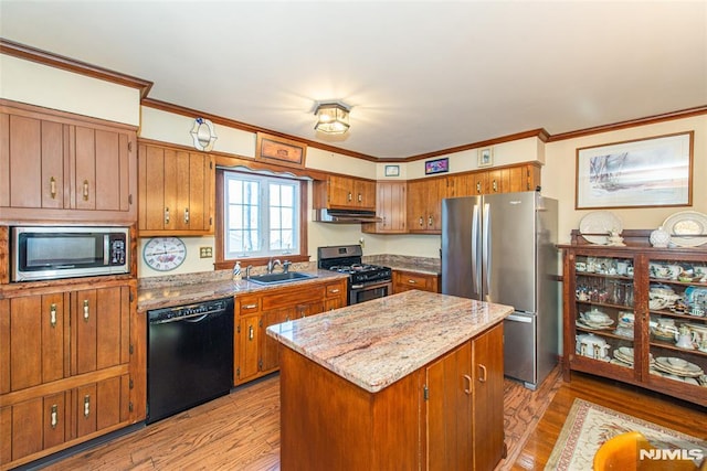 kitchen with stainless steel appliances, brown cabinets, and crown molding