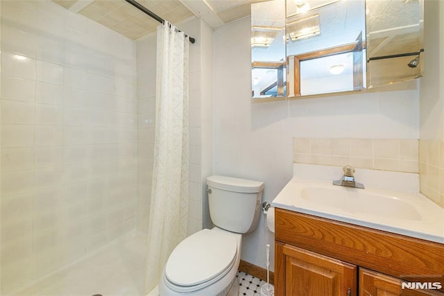 full bath with toilet, tasteful backsplash, tiled shower, and vanity