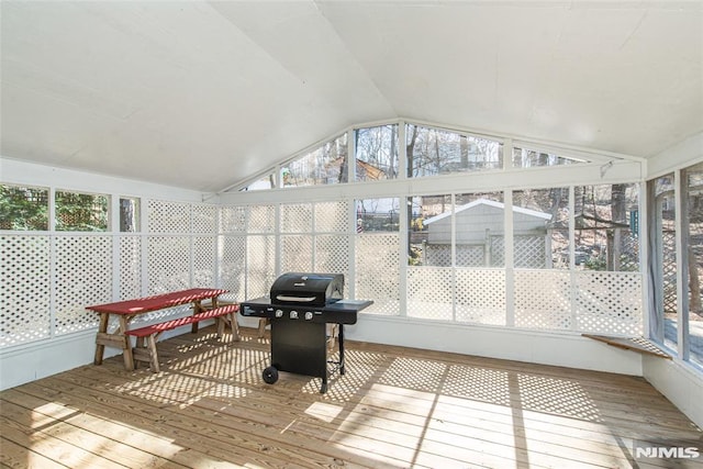 sunroom with a healthy amount of sunlight and vaulted ceiling