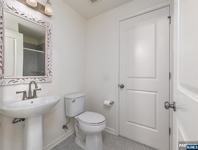 full bathroom with tile patterned flooring, toilet, a shower, and baseboards