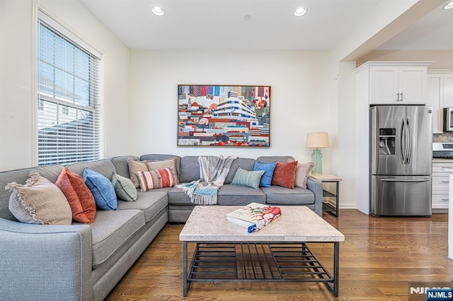 living room with recessed lighting and dark wood-style floors