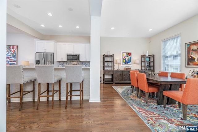 dining area featuring recessed lighting and dark wood-style floors