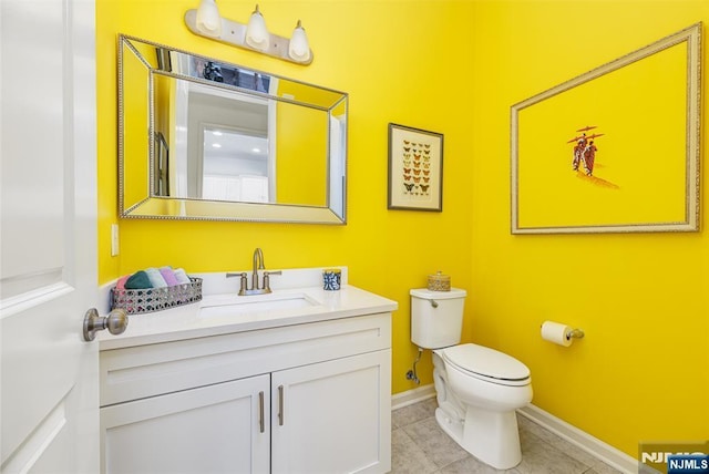 bathroom with tile patterned floors, baseboards, toilet, and vanity