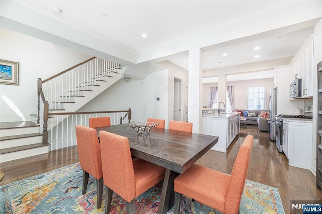 dining space featuring stairway, recessed lighting, and wood finished floors