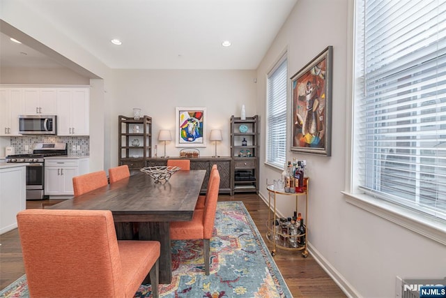 dining space featuring recessed lighting, baseboards, and dark wood-style flooring