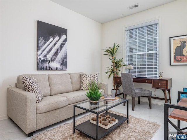 living room featuring baseboards, visible vents, and marble finish floor