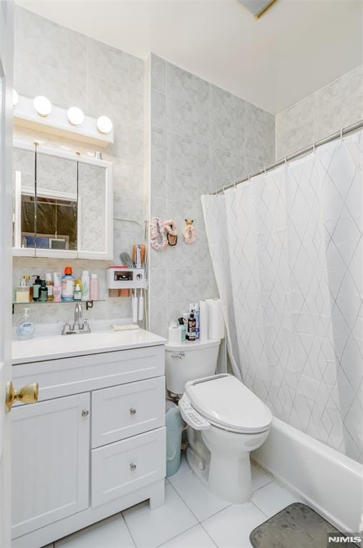 full bath featuring toilet, tile patterned flooring, tile walls, and vanity