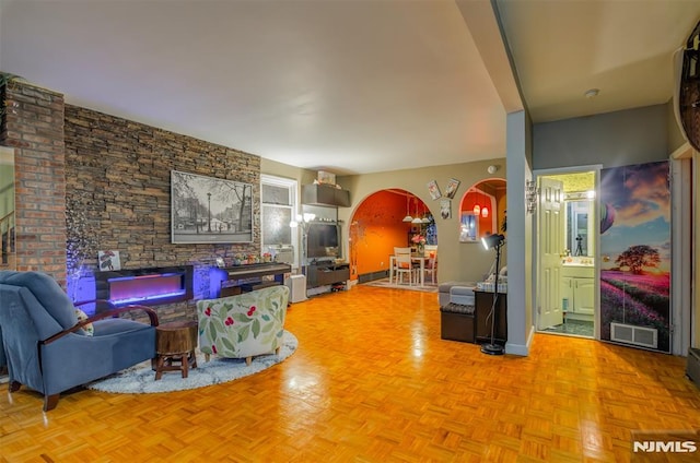 living room with visible vents and arched walkways