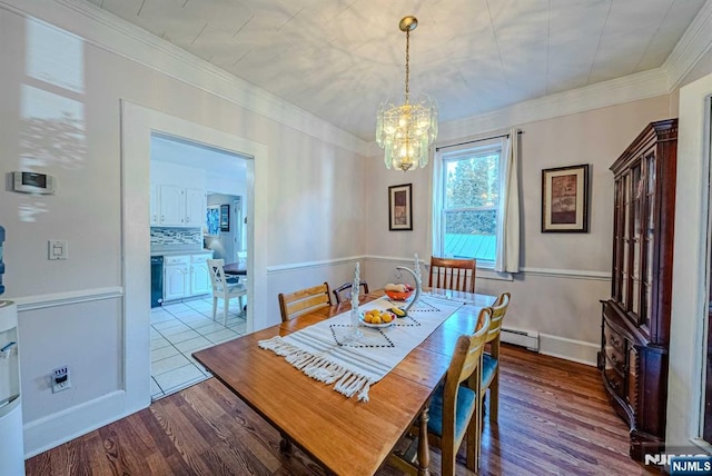 dining space featuring a baseboard radiator, a notable chandelier, dark wood-type flooring, baseboards, and ornamental molding