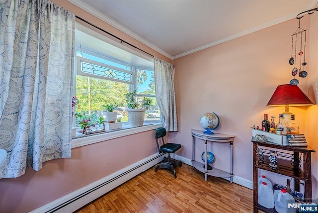 misc room featuring baseboards, a baseboard radiator, ornamental molding, and wood finished floors