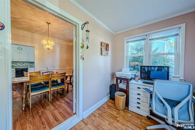 office area with baseboards, light wood-type flooring, a notable chandelier, and crown molding