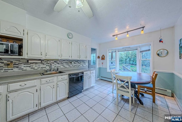 kitchen with black dishwasher, tasteful backsplash, stainless steel microwave, white cabinetry, and a sink