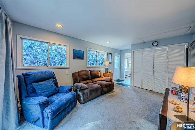 carpeted living room featuring recessed lighting and a baseboard radiator