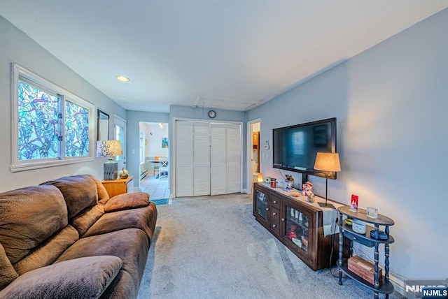 living room featuring carpet flooring and baseboards