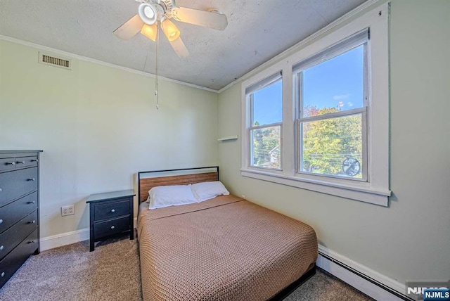 bedroom with a baseboard radiator, visible vents, crown molding, and carpet flooring