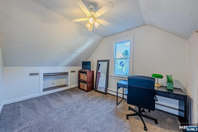 carpeted office with a baseboard heating unit, visible vents, vaulted ceiling, and baseboards