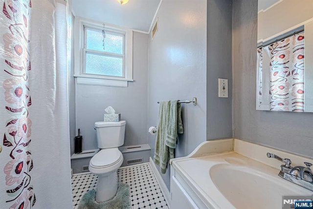 full bath featuring toilet, visible vents, and a sink