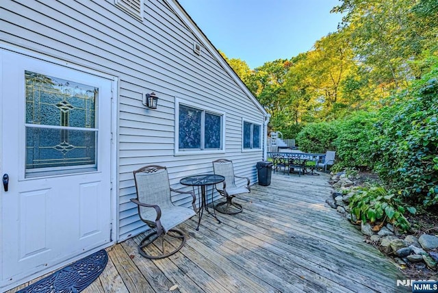 wooden deck featuring outdoor dining space