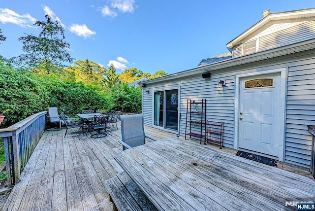 wooden deck featuring outdoor dining space