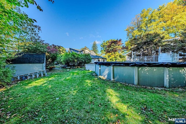 view of yard with an outbuilding and a covered pool