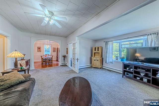 living area featuring arched walkways, a baseboard heating unit, french doors, and carpet flooring