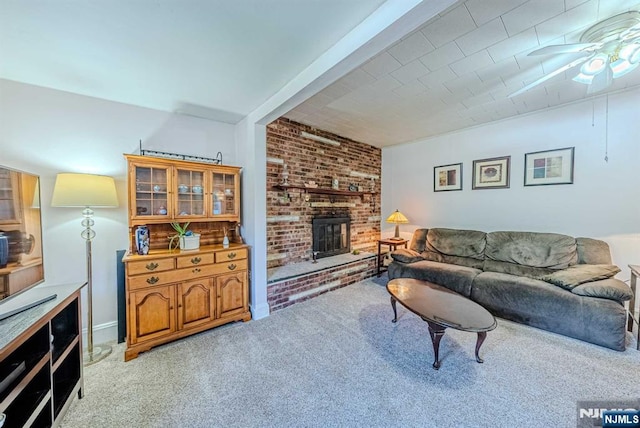 living room featuring light carpet, ceiling fan, and a fireplace