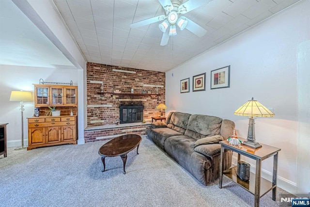 living room with carpet, a fireplace, a ceiling fan, and baseboards