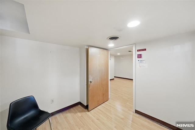 unfurnished office featuring baseboards, visible vents, and light wood-style flooring