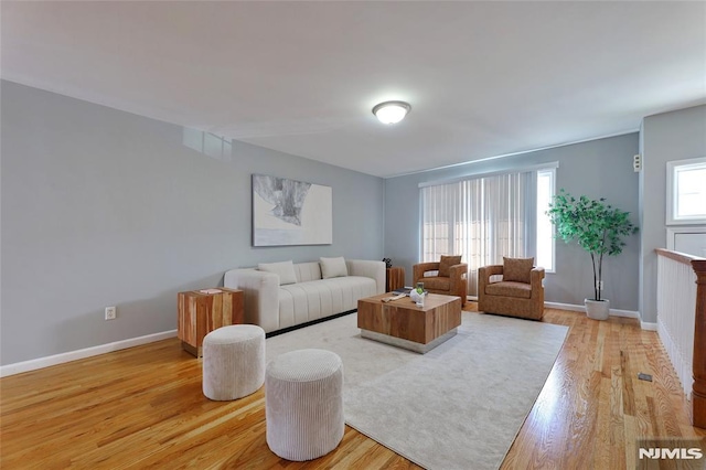 living room featuring light wood-type flooring and baseboards