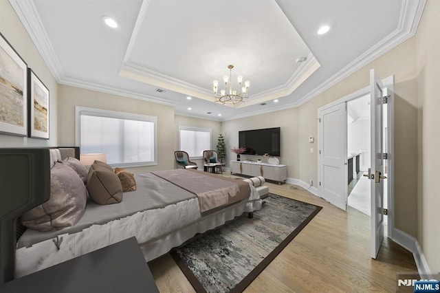 bedroom with recessed lighting, a raised ceiling, light wood-style flooring, an inviting chandelier, and baseboards