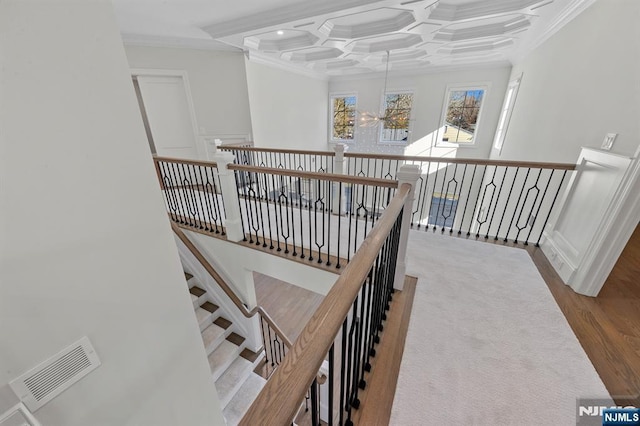 hallway with ornamental molding, beamed ceiling, coffered ceiling, and visible vents