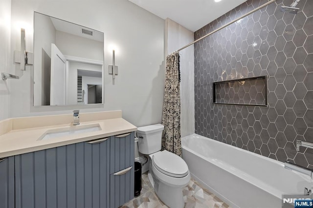 bathroom with visible vents, shower / tub combo with curtain, vanity, and toilet