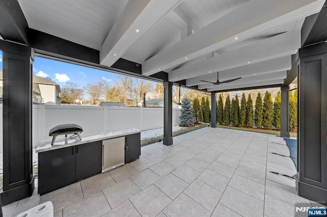 view of patio with a ceiling fan and fence