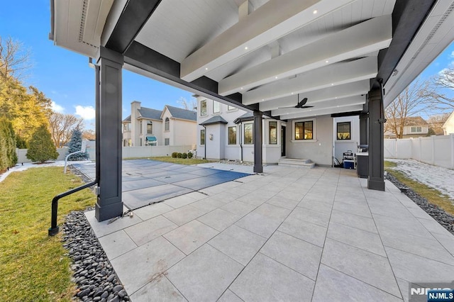 view of patio / terrace with ceiling fan and fence