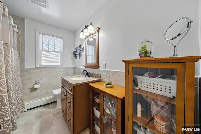 full bathroom with toilet, tile patterned flooring, a baseboard radiator, and tile walls