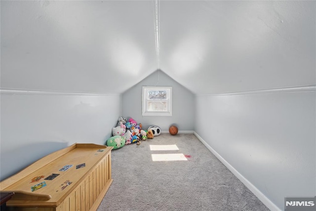 rec room featuring carpet flooring, vaulted ceiling, and baseboards