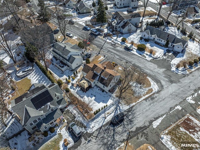 snowy aerial view with a residential view