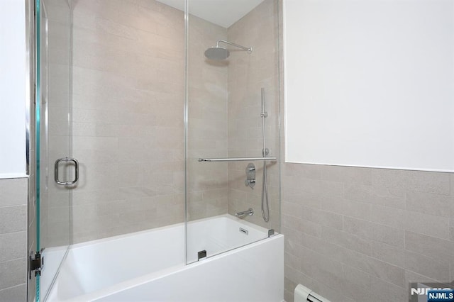 bathroom featuring a wainscoted wall, bath / shower combo with glass door, and tile walls